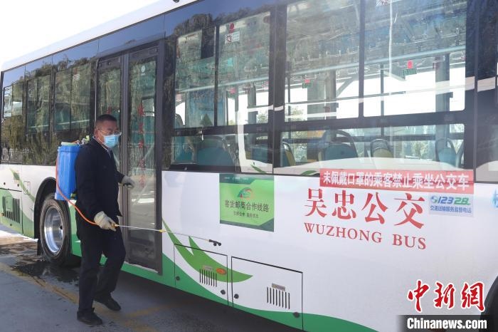 工作人員正在對(duì)公交車進(jìn)行消殺?！∮诰?攝