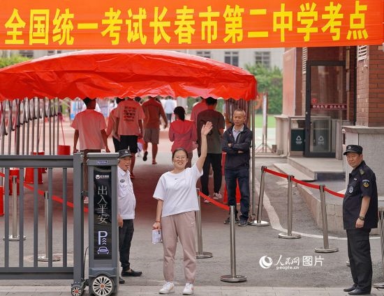6月7日，在長春市第二中學考點，一名考生信心滿滿進入考場，并與家長揮手致意。人民網(wǎng)記者 李洋攝