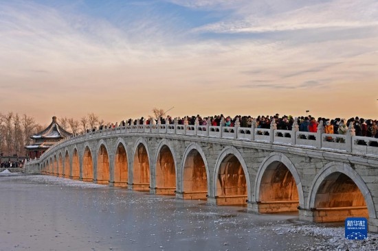 這是12月22日拍攝的頤和園十七孔橋“金光穿洞”景象。
