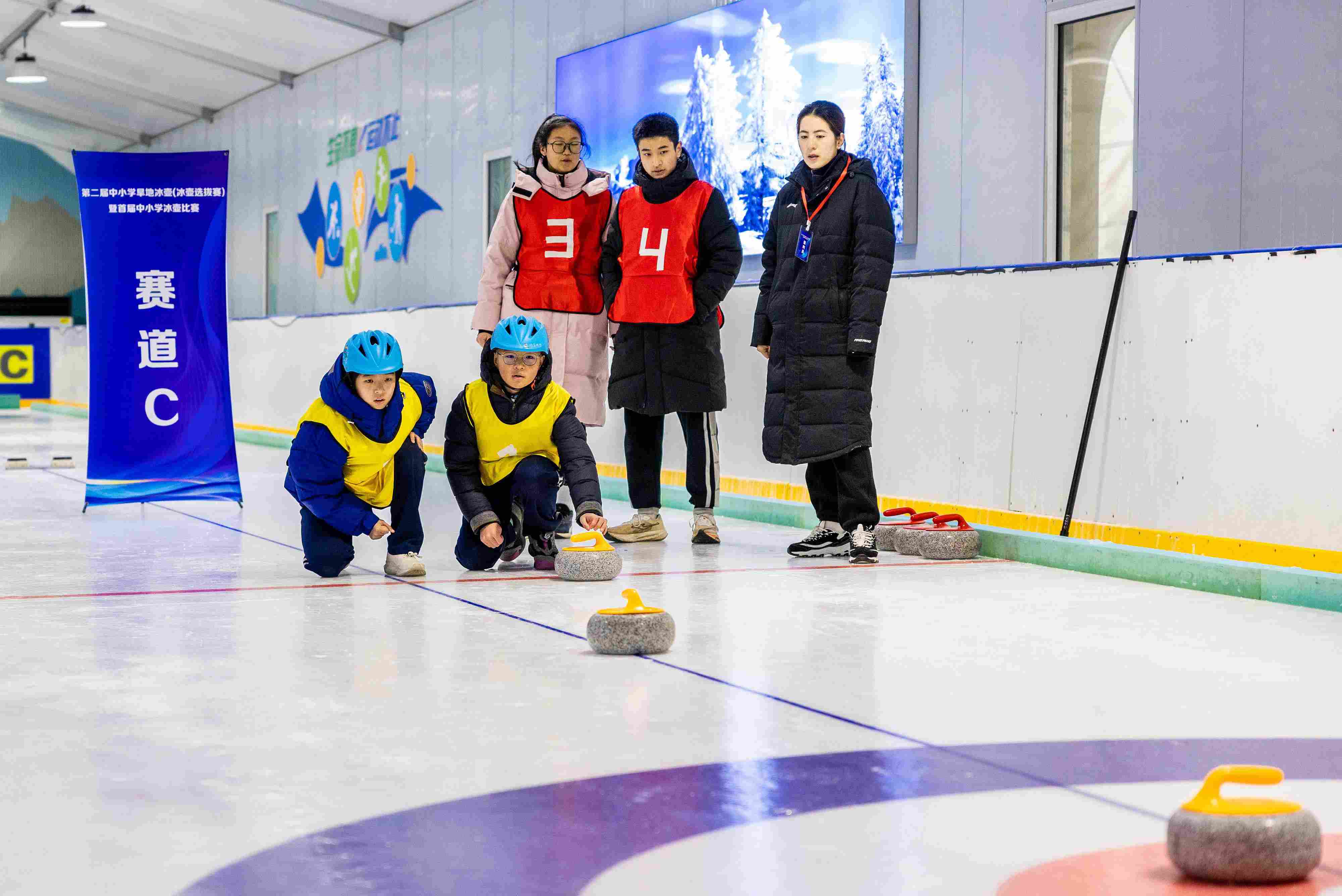 2023年12月10日，參賽選手在呼和浩特首屆中小學(xué)冰壺比賽中投擲冰壺。