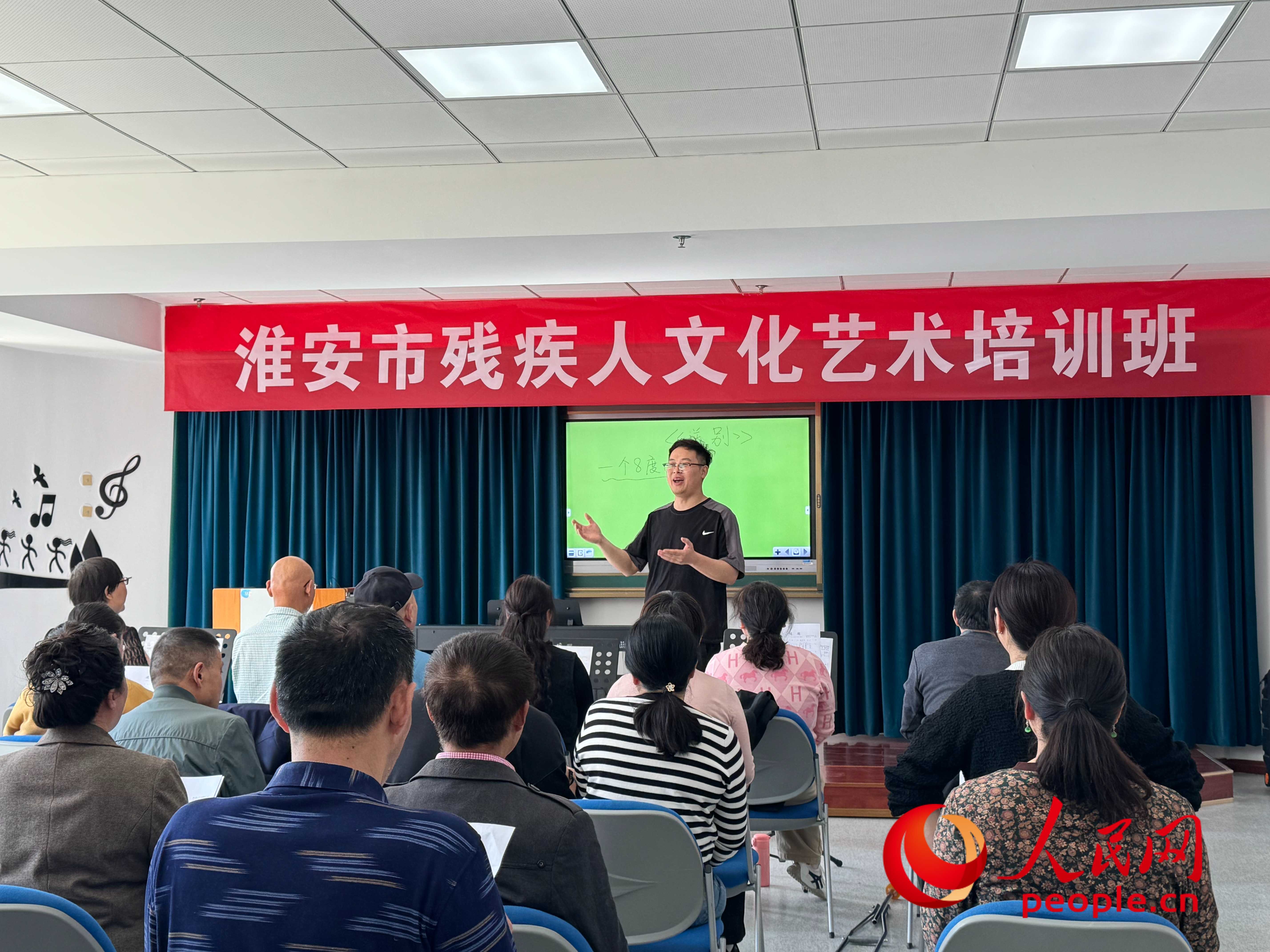 在淮安市殘疾人文化藝術(shù)培訓(xùn)班上，聲樂老師在教殘疾人唱《送別》這首歌曲。人民網(wǎng) 周靜圓攝
