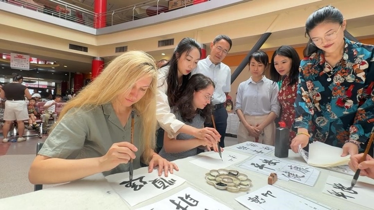 羅馬尼亞友人在活動(dòng)現(xiàn)場(chǎng)學(xué)寫漢字。中國(guó)駐羅馬尼亞大使館領(lǐng)僑處供圖