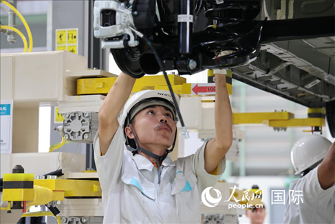 工人在廣汽埃安泰國智能生態(tài)工廠檢查汽車底座。 人民網記者 張矜若 攝
